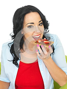 Young Woman Eating Wholewheat Cracker with Chocolate Spread and Fresh Sliced Strawberries