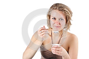 Young woman eating yoghurt