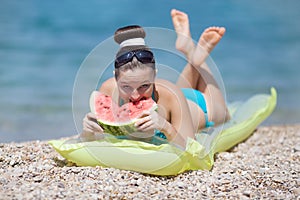 Young woman eats watermelon