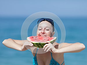 Young woman eats watermelon