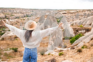 Young woman on the edge of canyon in Cappodocia