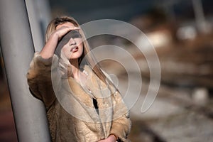 Young woman at the edge railway platform