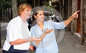 Young woman with elderly mother exploring city sights