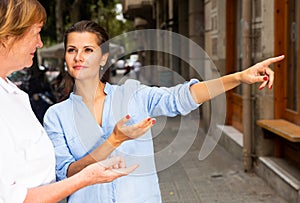 Young woman with elderly mother exploring city sights