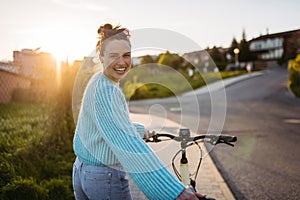 Young woman on electro bicycle, concept of commuting and ecologic traveling.