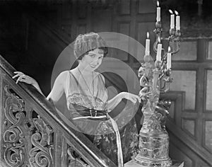 Young woman in an elegant dress walking down the steps