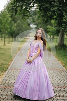 Young woman in elegant evening dress with hood, outdoors