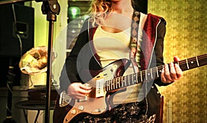 Young woman with an eletric guitar