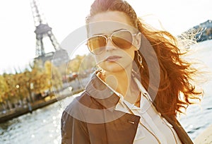 Young woman on embankment in Paris looking into the distance