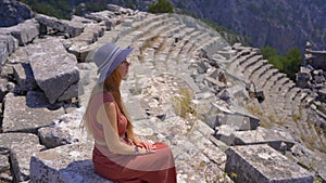 A young woman embarks on a cultural journey as she explores the breathtaking ruins of Termessos, nestled within the