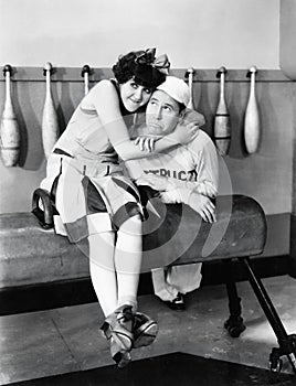 Young woman embracing a young man on a pommel horse photo