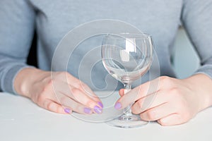 Young woman and empty wine glass