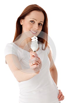 Young woman with energy efficient lightbulb.