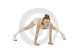 Young woman is engaged in fitness and yoga. Studio shot on white background