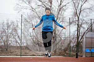 A young woman is engaged in jumping rope