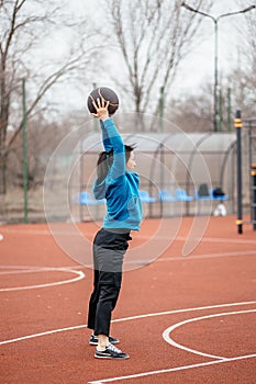 A young woman is engaged in sports on the Playground. Exercises with the medicine balls on the outdoor