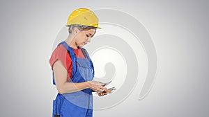 Young woman engineer or architect holding banknotes euros salary on gradient background.