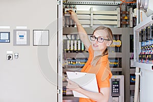 young woman engineer checking electrical cabinet