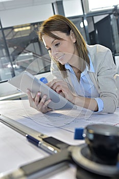 Young woman engineer workin at the office using a tablet