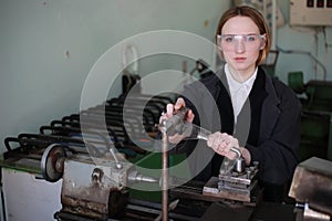 Young woman engineer working at machine tool