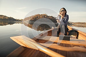 Young woman enjoy autumn canoe ride