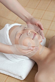 A young women lying in bed enjoying massage photo