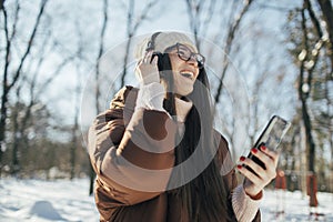 Young woman enjoy winter day and listening music