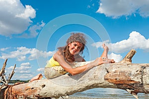 Young woman enjoy in yoga practice outdoor on river beach at freash air sunny summer day photo