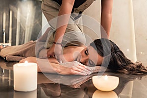 Young woman enjoying the acupressure techniques of Thai massage photo