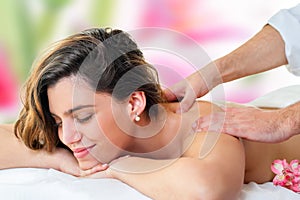 Young woman enjoying back massage.