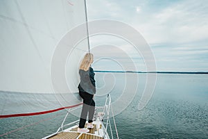 Young woman enjoying the beauty of the nature on sailing yacht sailing the sea