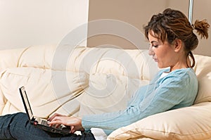 Young Woman Enjoying a Chat on her Laptop