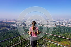 Young woman enjoying cityscape of Sao Paulo from Jaragua Peak viewpoint, Sao Paulo, Brazil photo