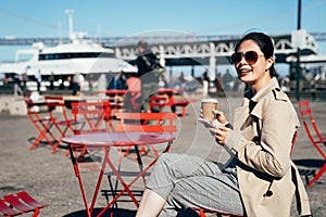 Young woman enjoying coffee sitting cafe outdoors