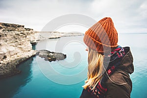 Young Woman enjoying cold sea view alone