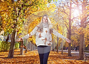 Young woman enjoying the colors of autumn