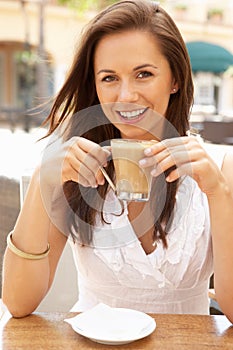Young Woman Enjoying Cup Of Coffee