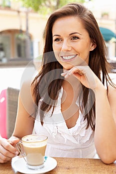 Young Woman Enjoying Cup Of Coffee