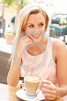 Young Woman Enjoying Cup Of Coffee