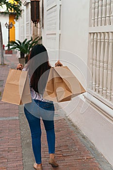 Young woman enjoying a day shopping with holding shopping bags. Enjoys shopping concept