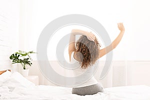 Young woman enjoying happy morning in bed