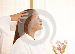 Young woman enjoying head massage