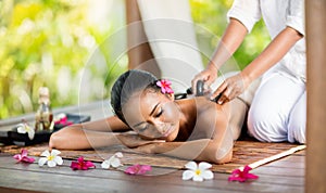 Young woman enjoying a hot stone massage