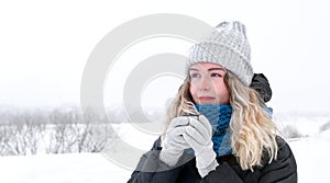 Young woman is enjoying hot tea outdoors. Winter travel