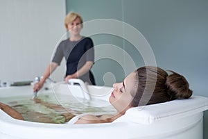 Young woman enjoying hydromassage in whirlpool bath