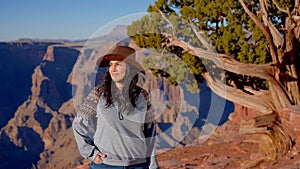 Young woman enjoying the incredibly impressive view over the majestic Grand Canyon