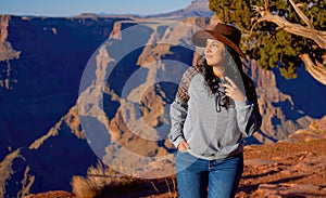Young woman enjoying the incredibly impressive view over the majestic Grand Canyon