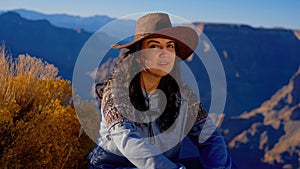 Young woman enjoying the incredibly impressive view over the majestic Grand Canyon