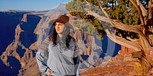 Young woman enjoying the incredibly impressive view over the majestic Grand Canyon