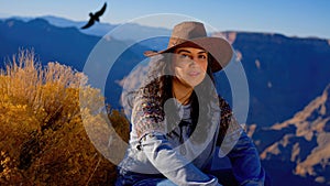 Young woman enjoying the incredibly impressive view over the majestic Grand Canyon